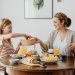 A warm family breakfast with mother and daughter sharing a meal in a cozy dining area.