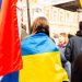 A peaceful protest in Zagreb, Croatia with participants holding Ukrainian flags, showing support and unity.